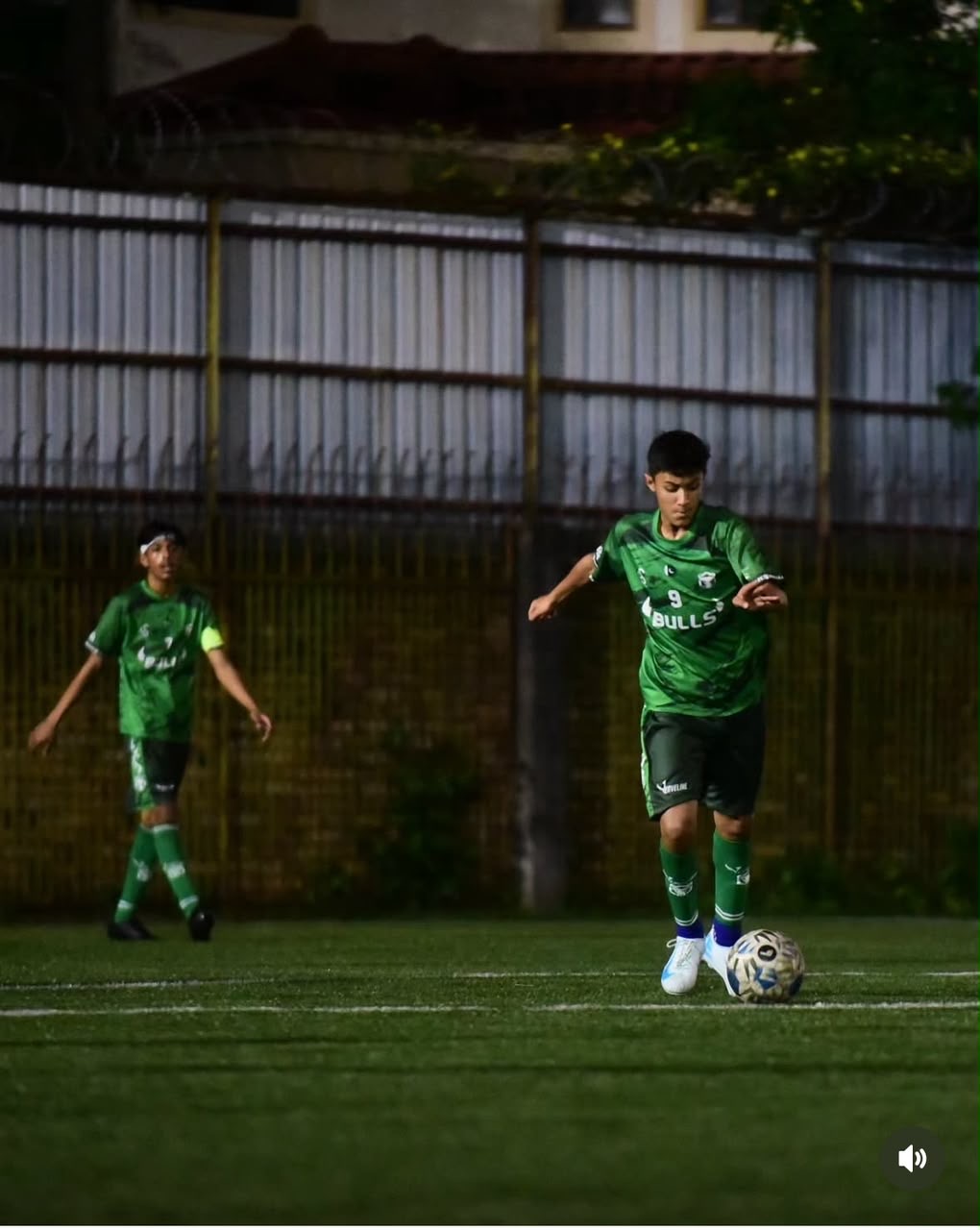 Zavyan Haider dribbling the football in a green kit